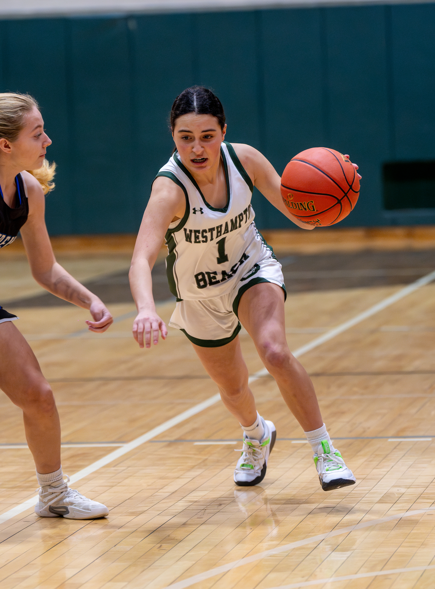 Westhampton Beach eighth-grader Mia Velez drives on a Centereach opponent late in the game on Friday evening.   RON ESPOSITO