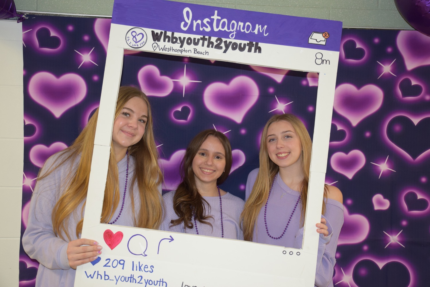 Students at Westhampton Beach High School spread kindness among their peers when they participated in P.S. I Love You Day on February 9.
Spearheaded by the school’s Youth to Youth Club, students were encouraged to wear the initiative’s symbolic purple and engage in random acts of kindness. Members of Youth to Youth also made bracelets with Best Buddies club members and the student body took part in a Unified Volleyball tournament. P.S. I Love You Day aims to raise awareness about bullying and suicide while promoting kindness.
Among those who helped with the effort were from left,  Youth to Youth board members Lily Pereyra, Maria Sfyroeras and Riley Arm. COURTESY WESTHAMPTON BEACH SCHOOL DISTRICT