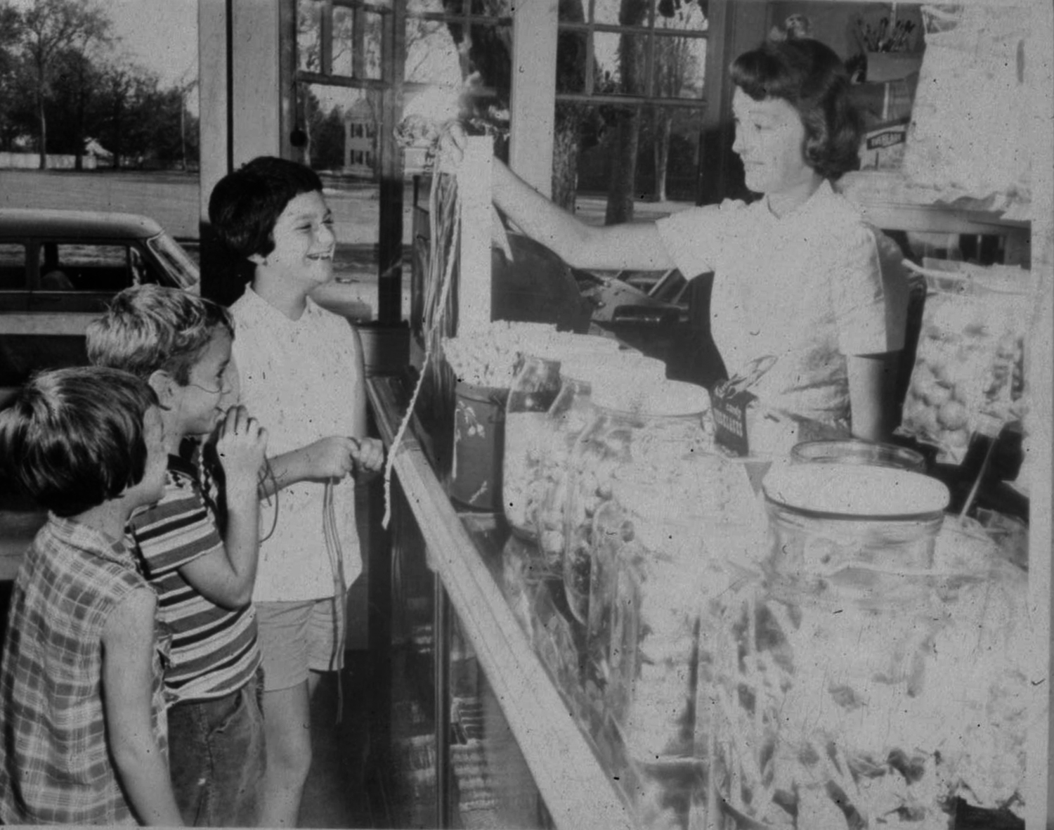 June Morris hands out candy to children at the Penny Candy Shop in the early 1960s.
