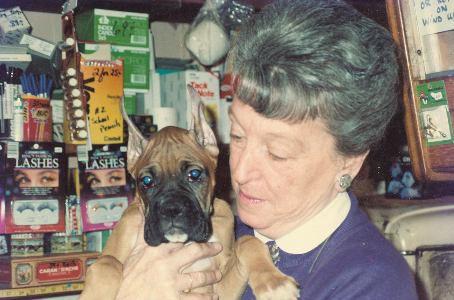 June Morris with her dog Chatter at the shop in October 1990.
