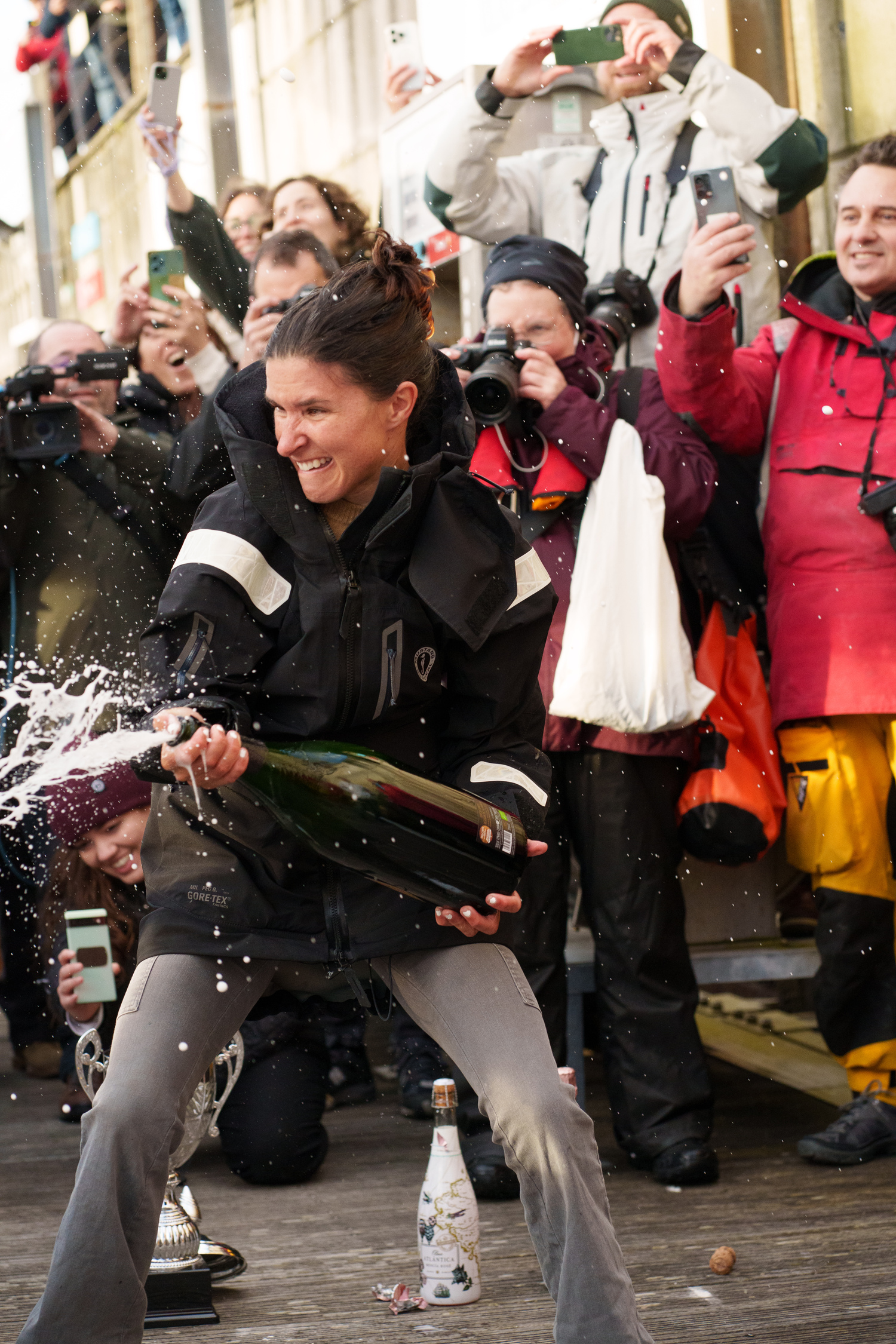 Cole Brauer shakes a bottle of champagne in celebration of her monumental achievement. ALVARO SANCHIS