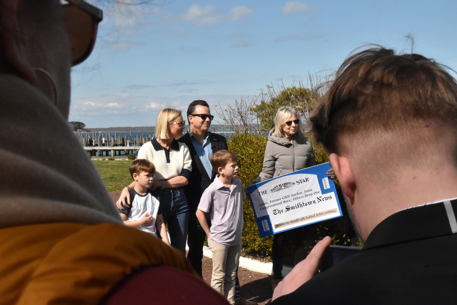 Former CNN anchor and author John Avlon, who kicked off his congressional campaign with a rally in Marine Park in Sag Harbor on Saturday, waits with his wife Margaret Hoover and children to be introduced.  STEPHEN J. KOTZ