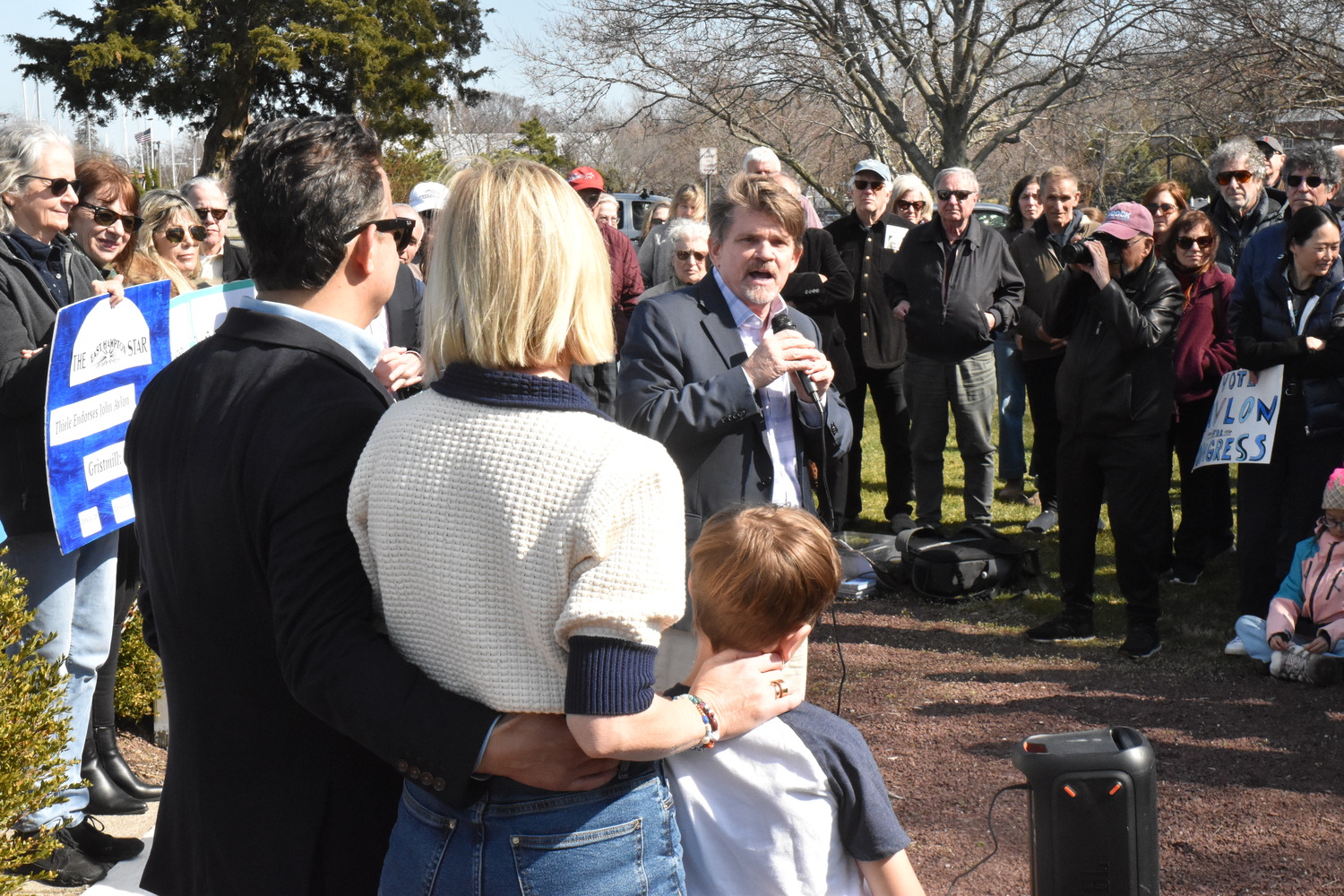 Southampton Town Councilman Tommy John Schiavoni, who is running for the State Assembly, speaks while congressional candidate John Avlon and his family look on. STEPHEN J. KOTZ