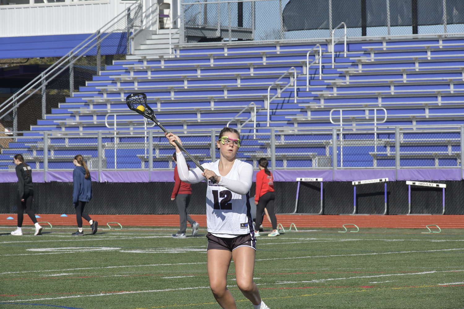 Members of the Hampton Bays girls lacrosse team practice prior to their scrimmage against the Stony Brook School on Monday.  DANA SHAW