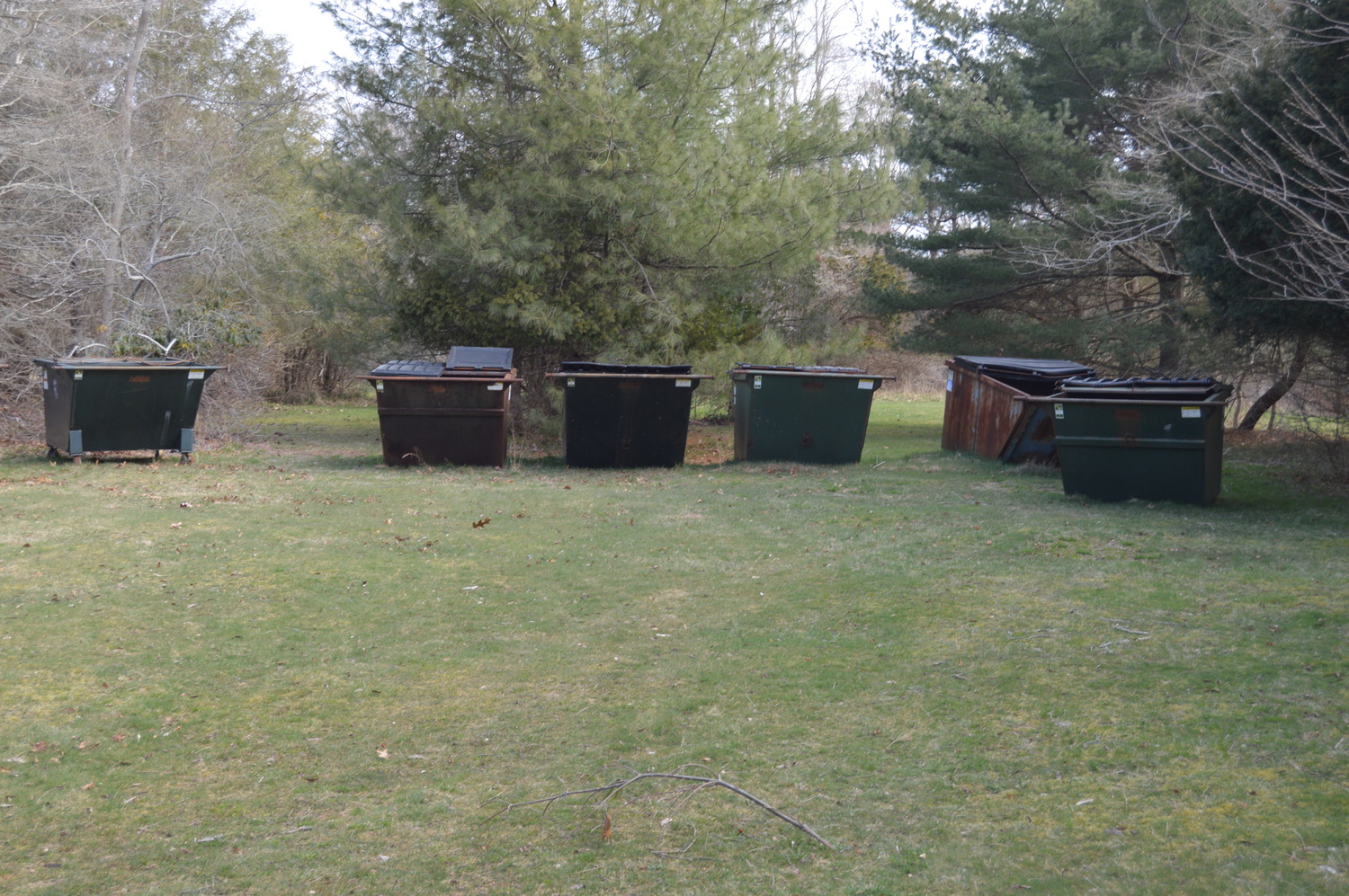 A family of dumpsters awaits its fate at the Mill Road site of a proposed Westhampton Community Center. TOM GOGOLA