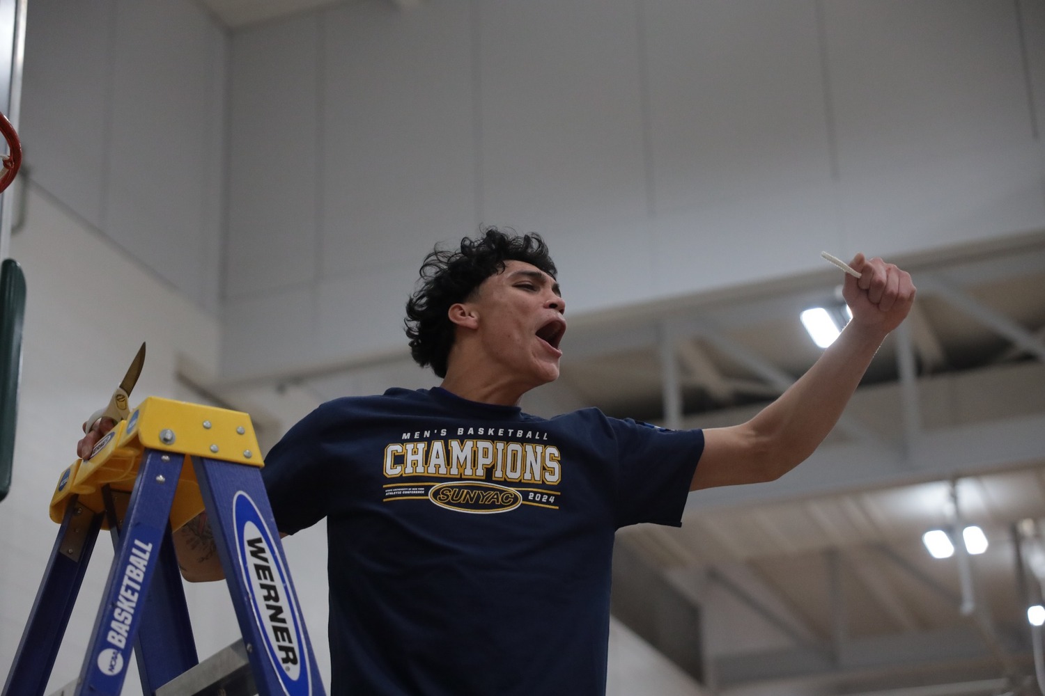 Dakoda Smith helps cut down the nets after SUNY New Paltz won the SUNYAC Championship last month.   COURTESY SUNY NEW PALTZ ATHLETIC COMMUNICATIONS