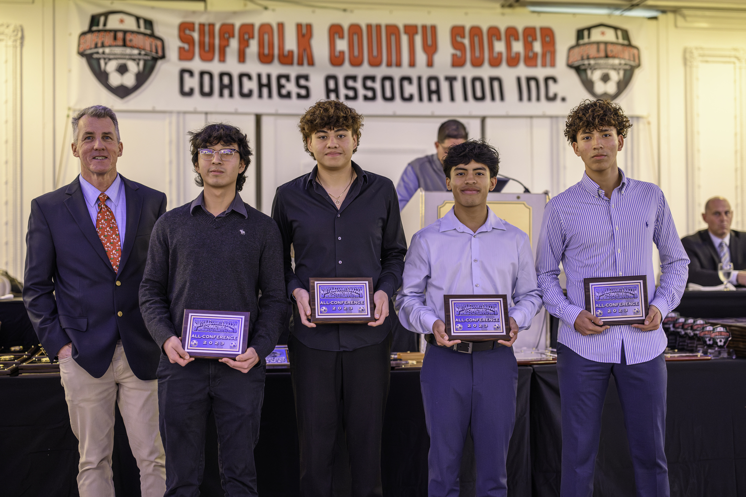 East Hampton boys soccer head coach Don McGovern with his All-Conference selections Brian Tacuri, left, Kevin Hilario and Jonathon Armijos Calle and. John Bustamante.   MARIANNE BARNETT