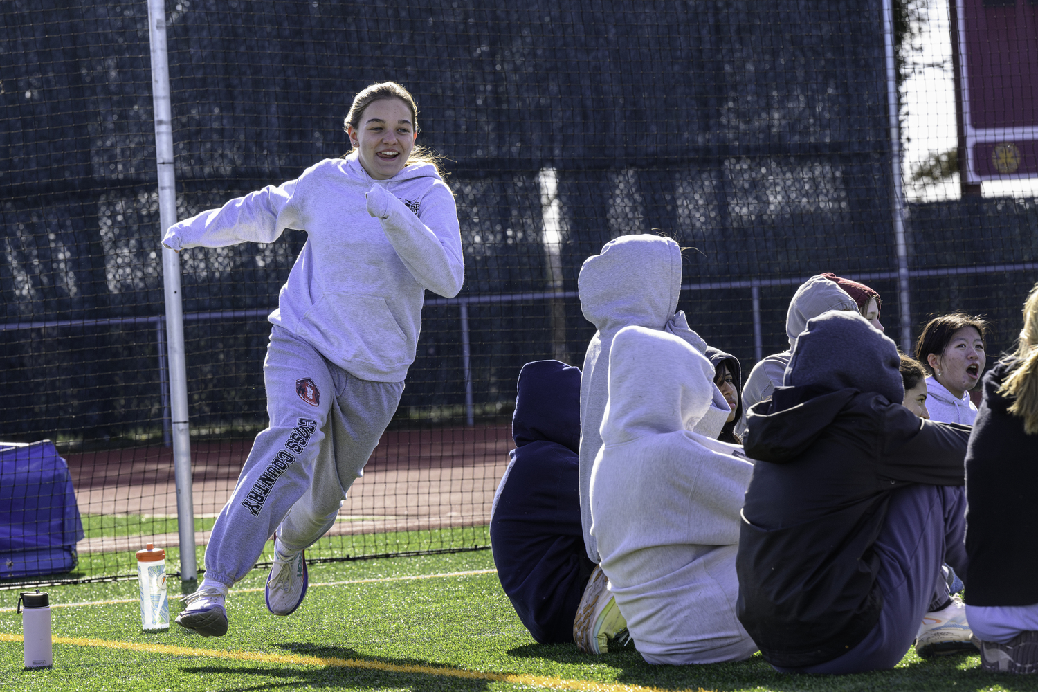 Greylynn Guyer gets a game of duck, duck, goose with the rest of her Bonac teammates at practice on Thursday, March 21.  MARIANNE BARNETT