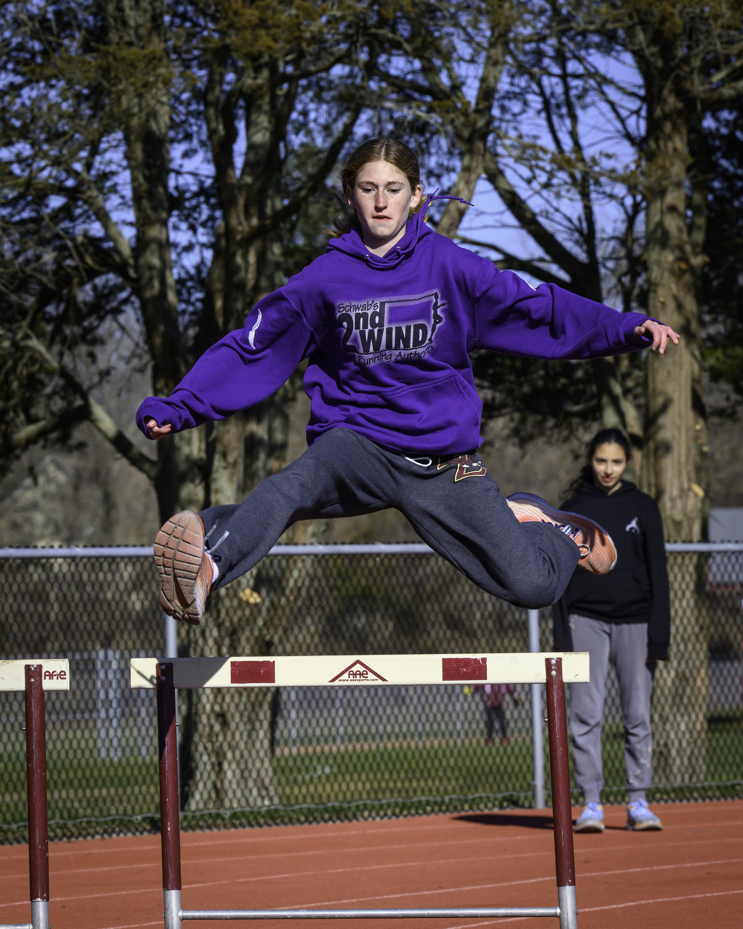 Sara O'Brien leaps over a hurdle in practice.   MARIANNE BARNETT