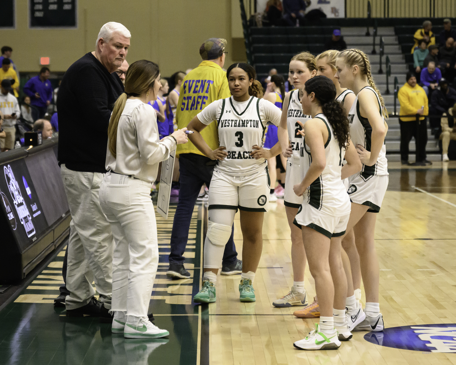 Westhampton Beach's girls basketball team huddles up for its final timeout of the game. MARIANNE BARNETT