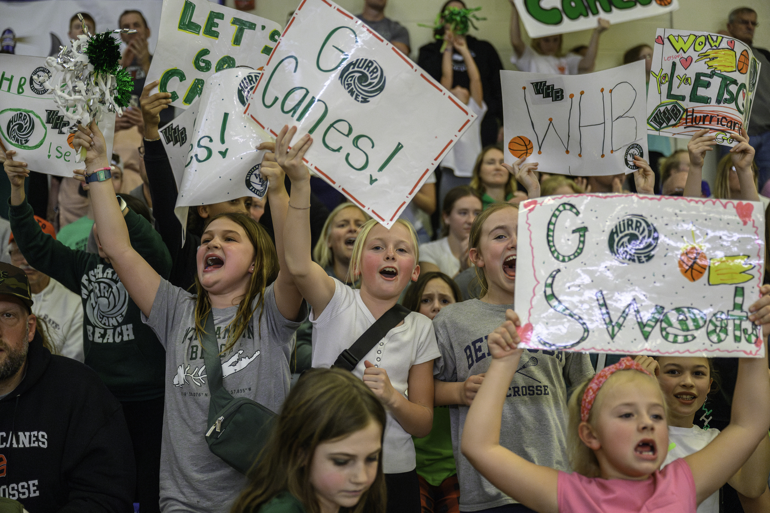 Young Westhampton Beach fans raise up handmade signs while celebrating a Hurricane basket. MARIANNE BARNETT