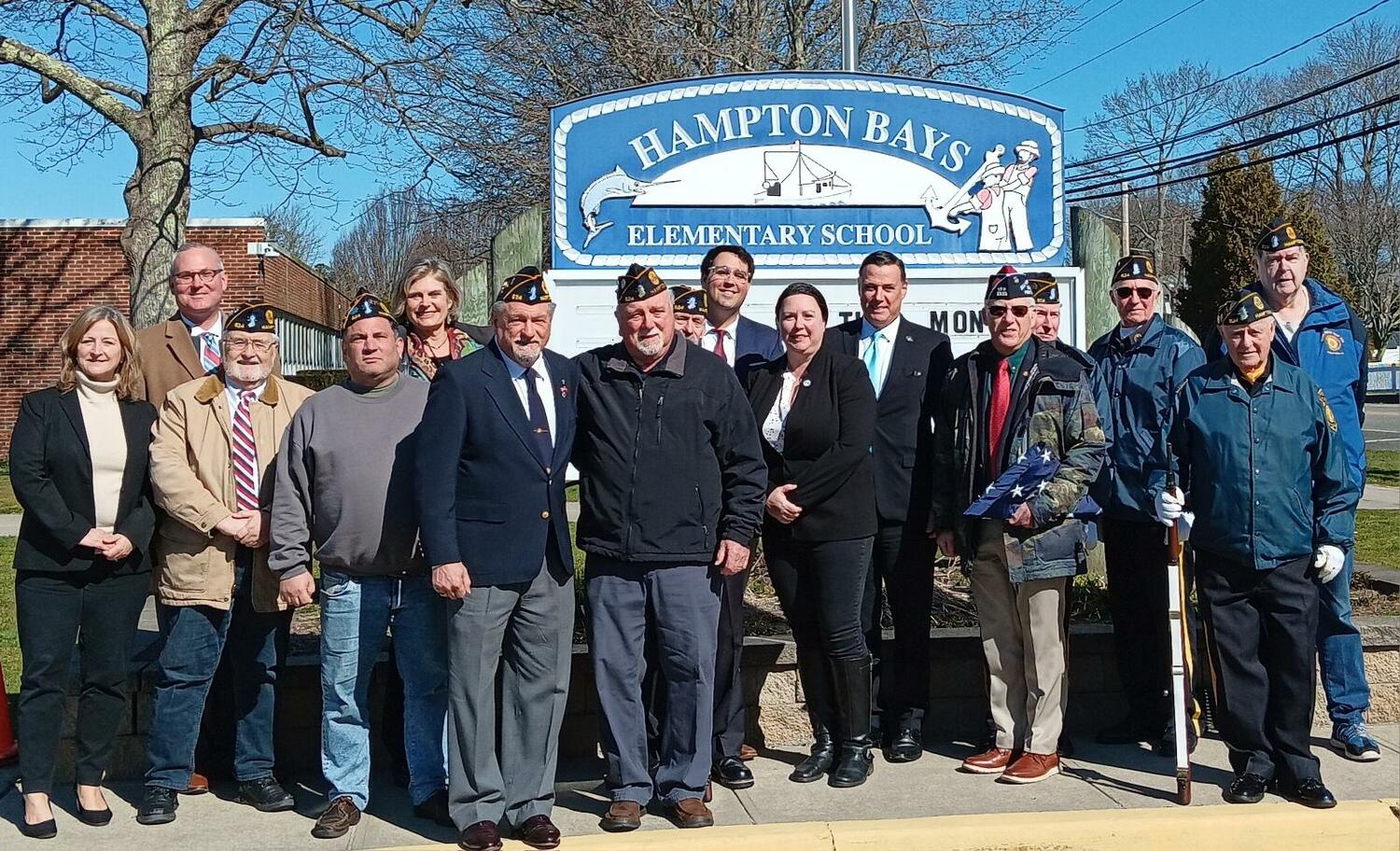 Hampton Bays School District honored veteran Sal Traversa with a flag raised in his honor on March 22. Traversa is a member of  American Legion Post #924 Hampton Bays and still serves the community. The event was attended by many Veterans and elected officials including NYS Senator Anthony Palumbo, Suffolk County Legislator Ann Welker, Southampton Town Supervisor Maria Moore, Councilwoman Cyndi McNamara, Councilman Michael Iiselli and Hampton Bays Schools Superintendent Lars Clemensen.  COURTESY WILLIAM HUGHES
