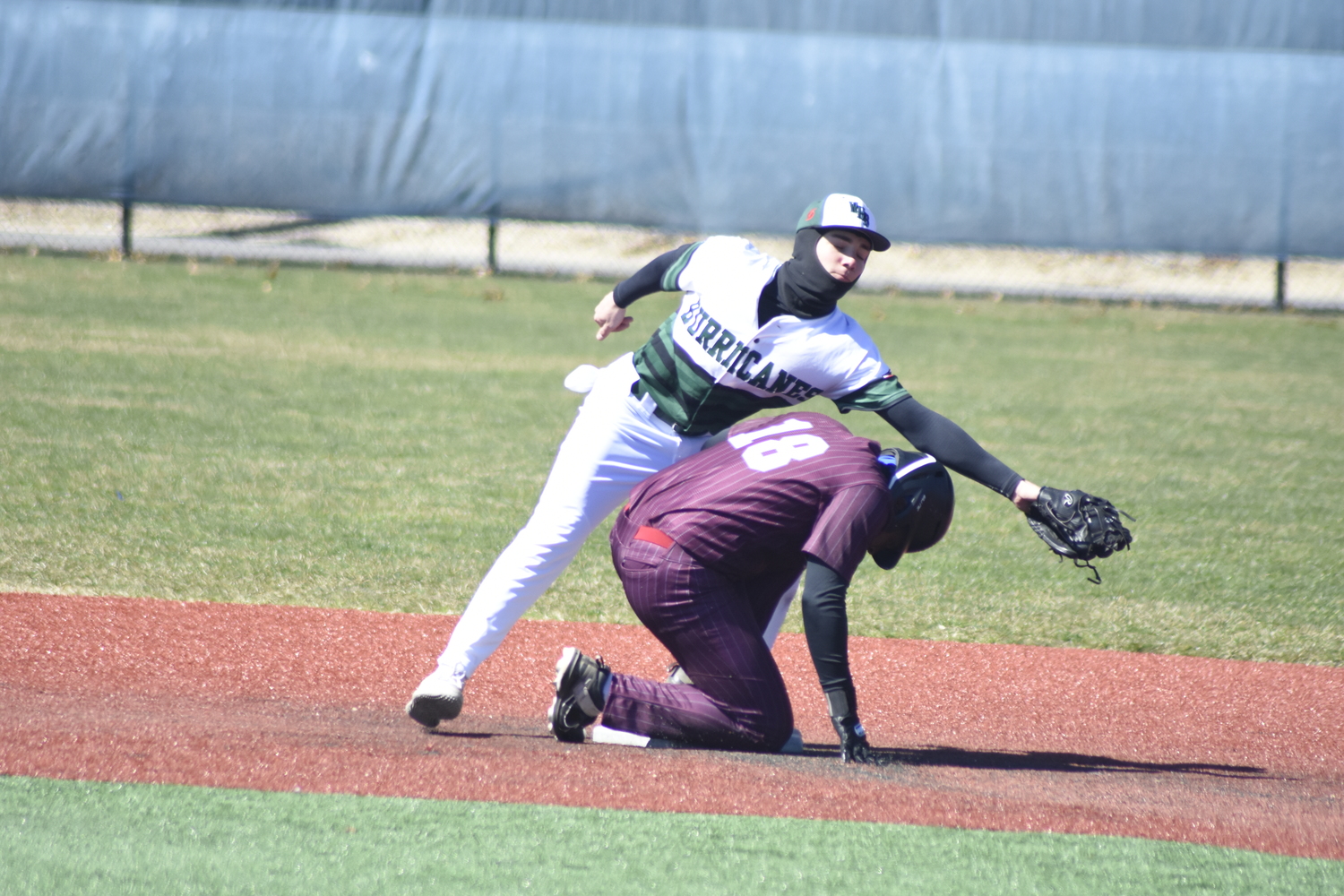 Patrick Fay reaches out to catch a bouncing ball and keep it from going into center field. DREW BUDD