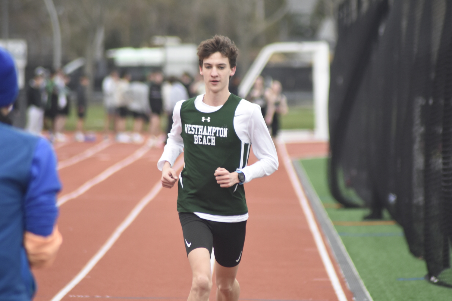 Westhampton Beach senior Trevor Hayes crosses the finish line in the 1,600-meter race in which he dominated.   DREW BUDD