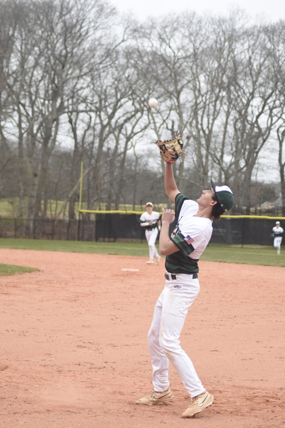 Westhampton Beach first baseman Jude Allen lines up a fly ball in the infield and catches it for an out.   DREW BUDD