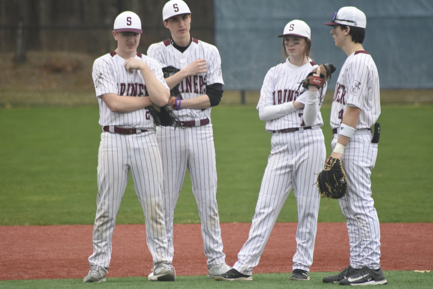 Daniel McDonnell, left, Declan Barbour, Bailey Brown and Cooper Helmsteadt watch Jackson Romanow take his warmup pitches during a pitching change.   DREW BUDD