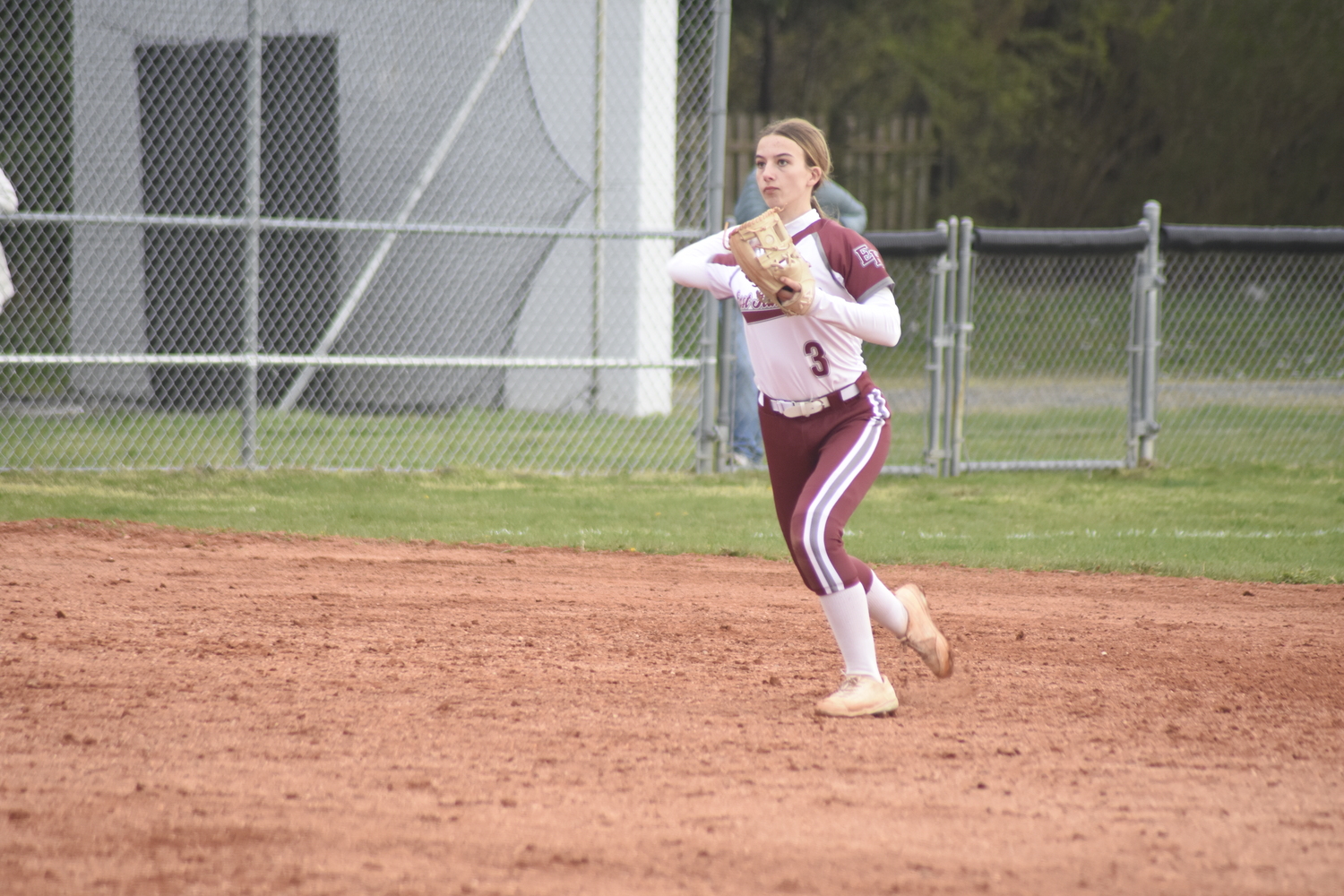 East Hampton sophomore shortstop Olivia Dodge throws to first for an out. DREW BUDD