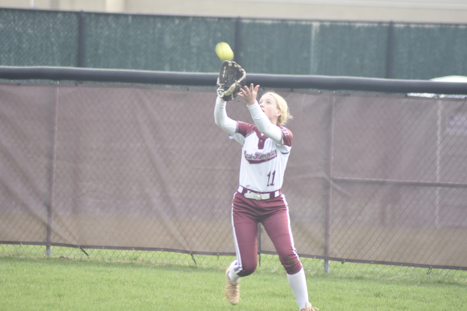 East Hampton sophomore Lydia Rowan catches a fly ball in center field. DREW BUDD