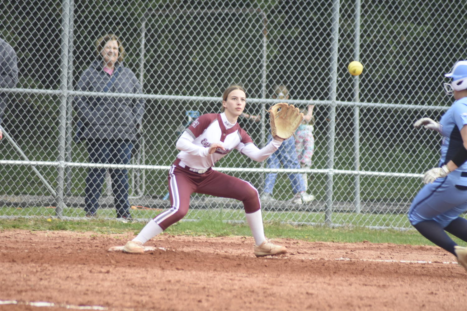 Olivia Dodge takes a throw at third base with a Rocky Point baserunner bearing down on her. DREW BUDD