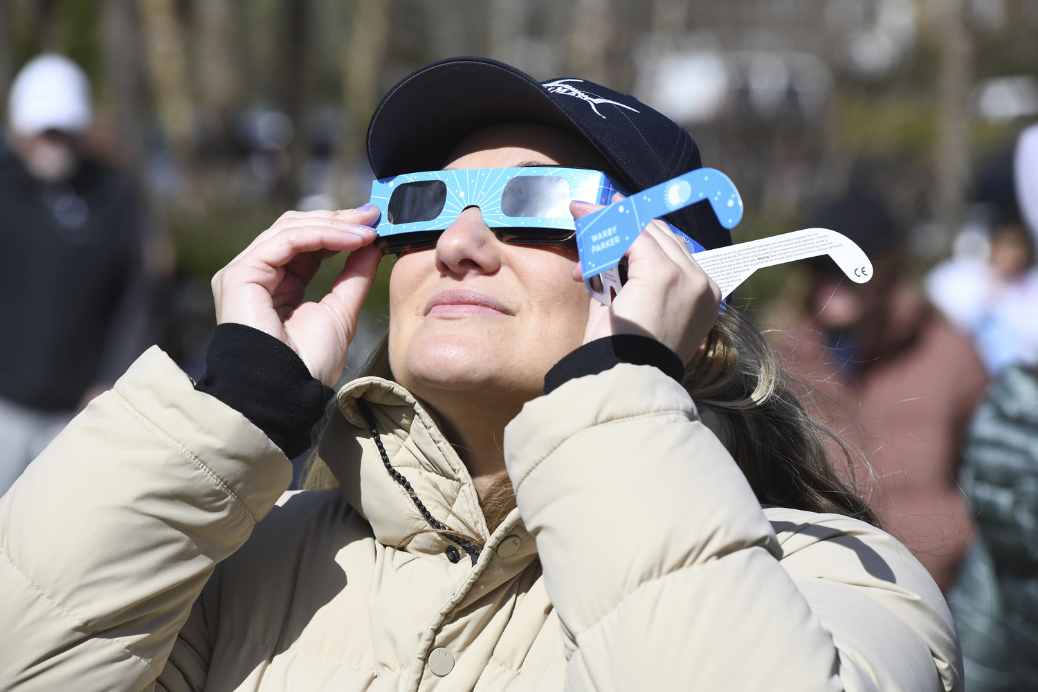 Caitlin Martello views the eclipse at the East Hampton Library on Monday afternoon.