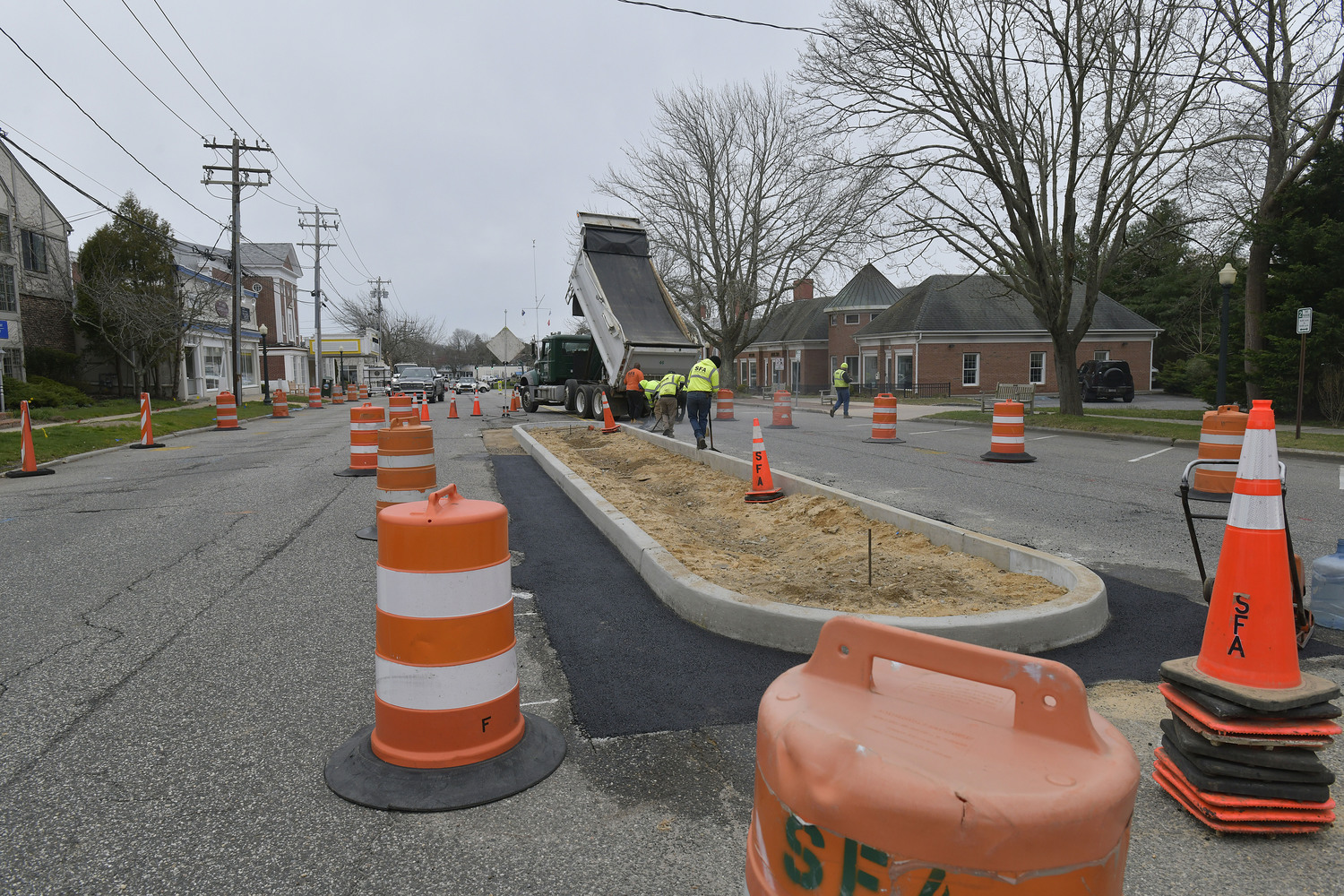 Work began last week in Southampton Village to create a turning lane and pedestrian islands on Hill Street near First Neck Lane and Varadian Way.  DANA SHAW