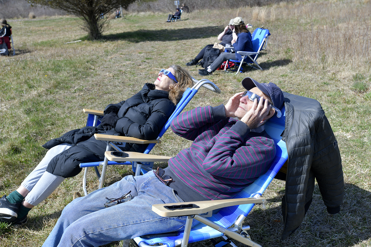 Brahna Yassky and Bruce Janovsky watch the eclipse at the South Fork natural History Museum in Bridgehampton on Monday afternoon.