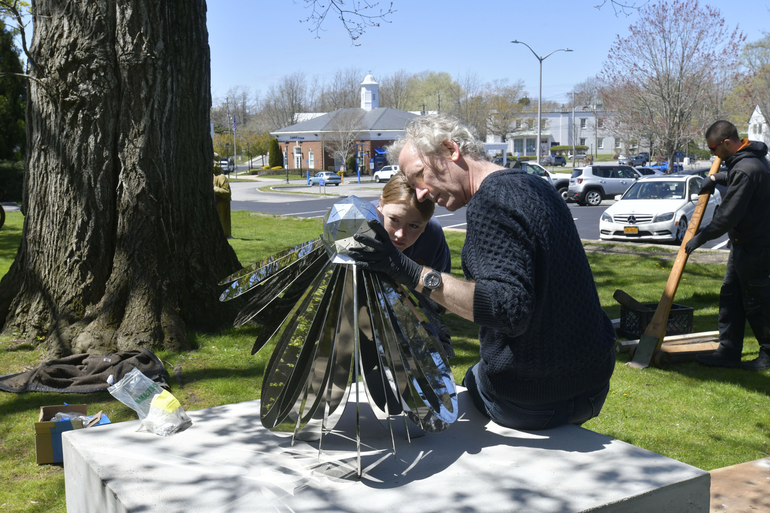 Norman Mooney and Heather Mooney install Mr. Mooney's sculpture 