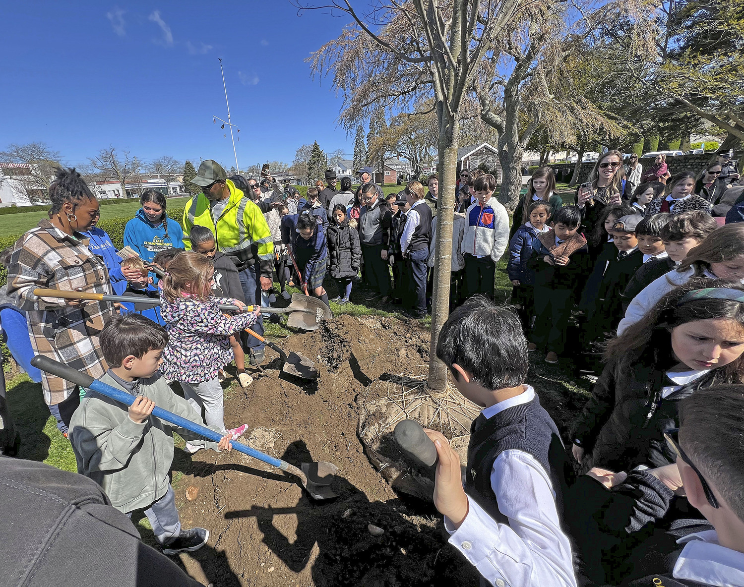 Students from Our Lady of the Hamptons and children from the Southampton Youth Association plant a tree in Agawam park in Southampton Village on Friday in honor of Arbor Day. The Southampton Village was named a 2023 Tree City USA by the Arbor Day Foundation to honor its commitment to effective urban forest management.  The Tree City USA program is sponsored by the Arbor Day Foundation, in partnership with the U.S. Forest Service and the
National Association of State Foresters.    DANA SHAW