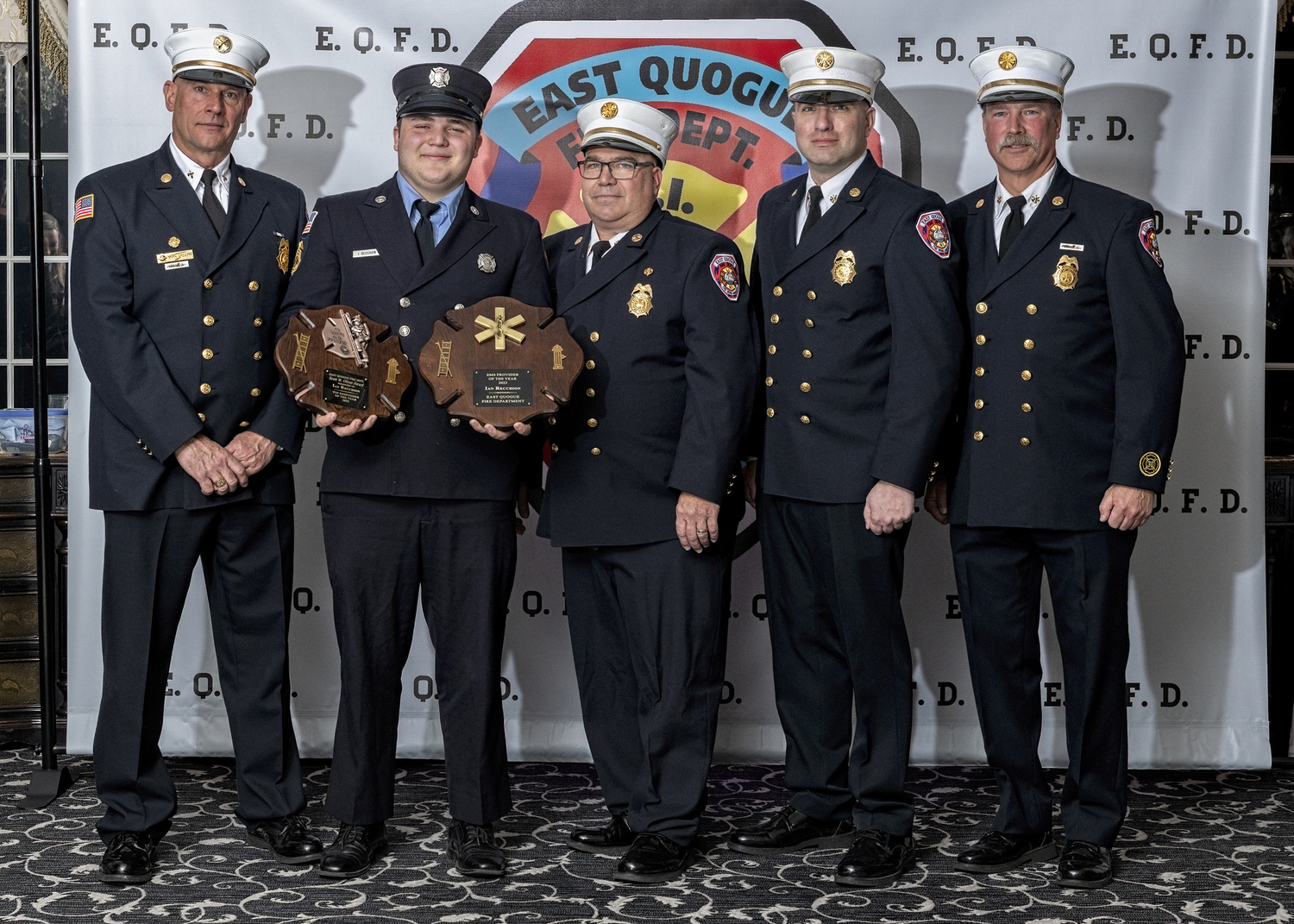 The East Quogue Fire Department held its annual dinner at Georgio’s in Calverton on March 22. Ian Recchion, holding plaques,was honored at the dinner as the 2023 EMS Provider of the Year. He also received the Scott W. Oliver Award for Top Responder. With him are (from the left) Third Assistant Chief Mark Gregory, Chief Paul Sulzinski, First Assistant Chief Keith Phillips, and Second Assistant Chief Glenn Bullock.    COPURTESY WESTHAMPTON BEACH FIRE DEPARTMENT