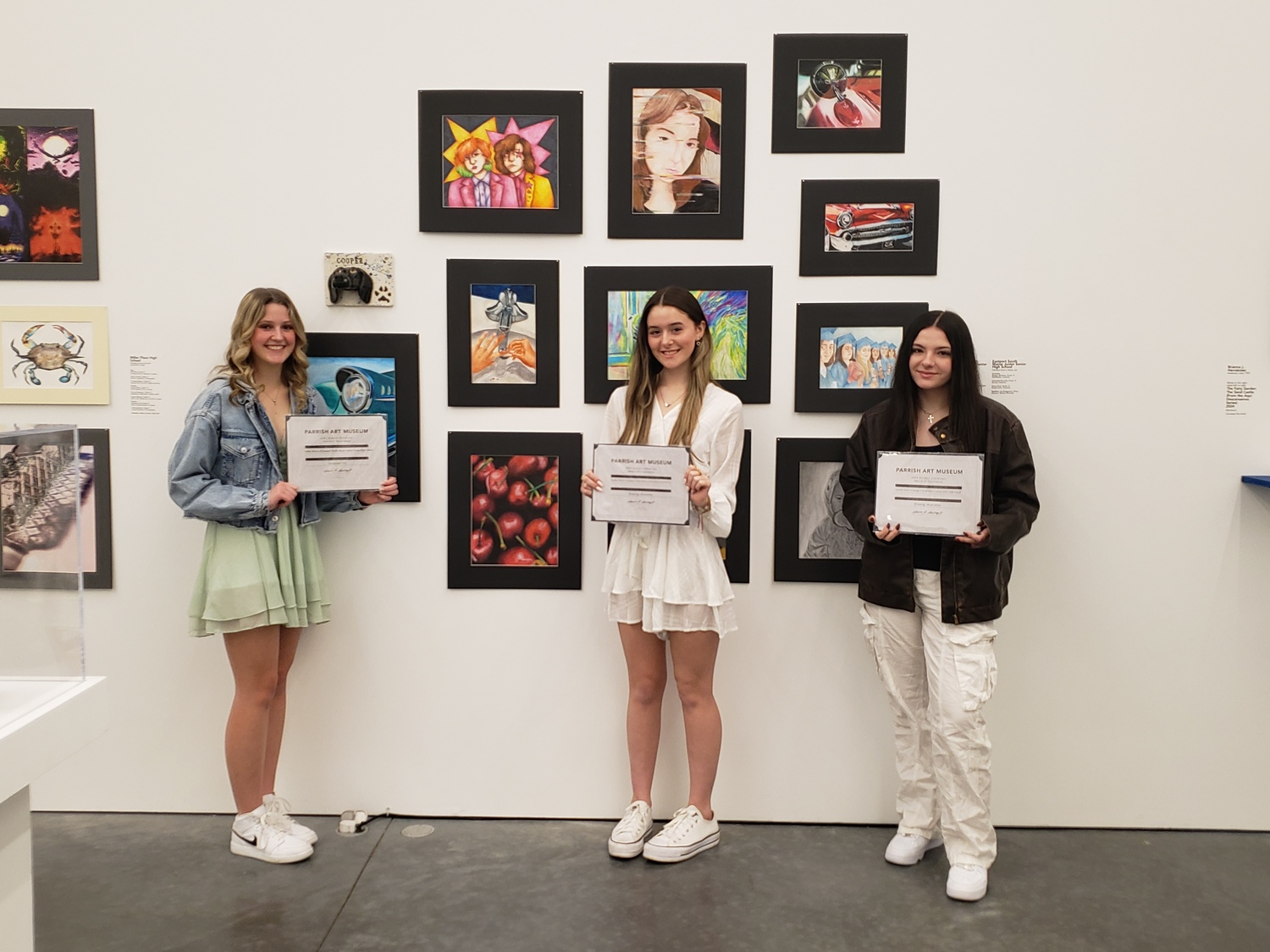 Eastport-South Manor Jr.-Sr. High School seniors Hailey Grieco, left, Heather Moran and Daniella Dolce, right,  received Awards of Excellence from the Parrish Art Museum for their work in the Student Exhibition. COURTESY EASTPORT-SOUTH MANOR SCHOOL DISTRICT