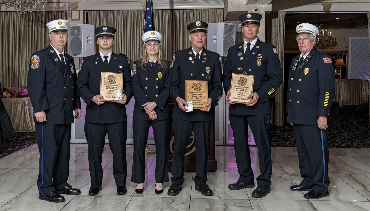 Joseph Dalen, Paul Massey, and Edward Schneyer, holding plaques, shared honors as the Firefighters of the Year at the Eastport Fire Department's 2024 Installation Dinner at Georgio’s in Calverton on  April 13.    COURTESY EASTPORT FIRE DEPARTMENT