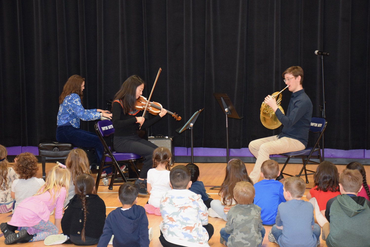 Hampton Bays Elementary School students were treated to a special assembly with the musical group the Cecilia Trio. The group, comprising a violinist, a hornist and a pianist, performed for the students and taught them about the moods of music and how musicians create them. COURTESY HAMPTON BAYS SCHOOL DISTRICT