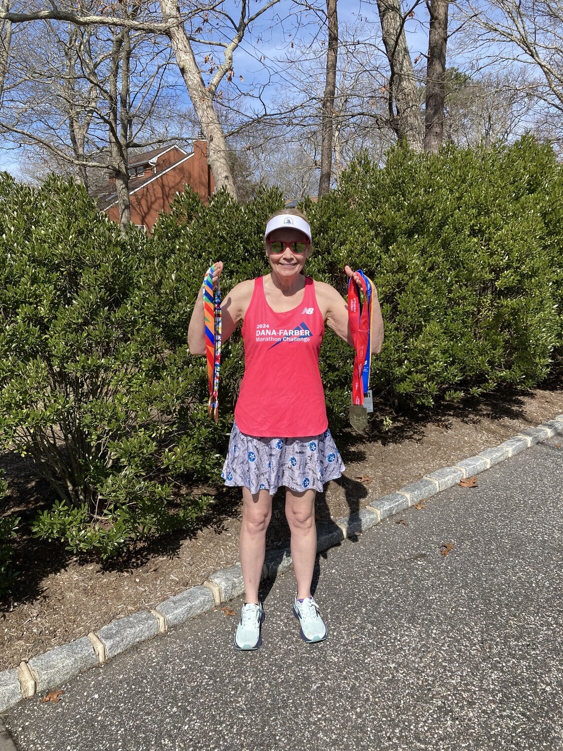 Gail Miranda of Hampton Bays with the five medals she earned from completing five of the six major marathon around the world, which includes New York City, Chicago, London, Berlin and Tokyo.   COURTESY GAIL MIRANDA
