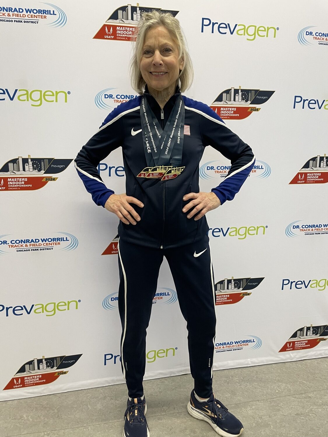 Joy Flynn with her five medals that she won at the USATF Masters Indoor Nationals.   COURTESY DAN FLYNN