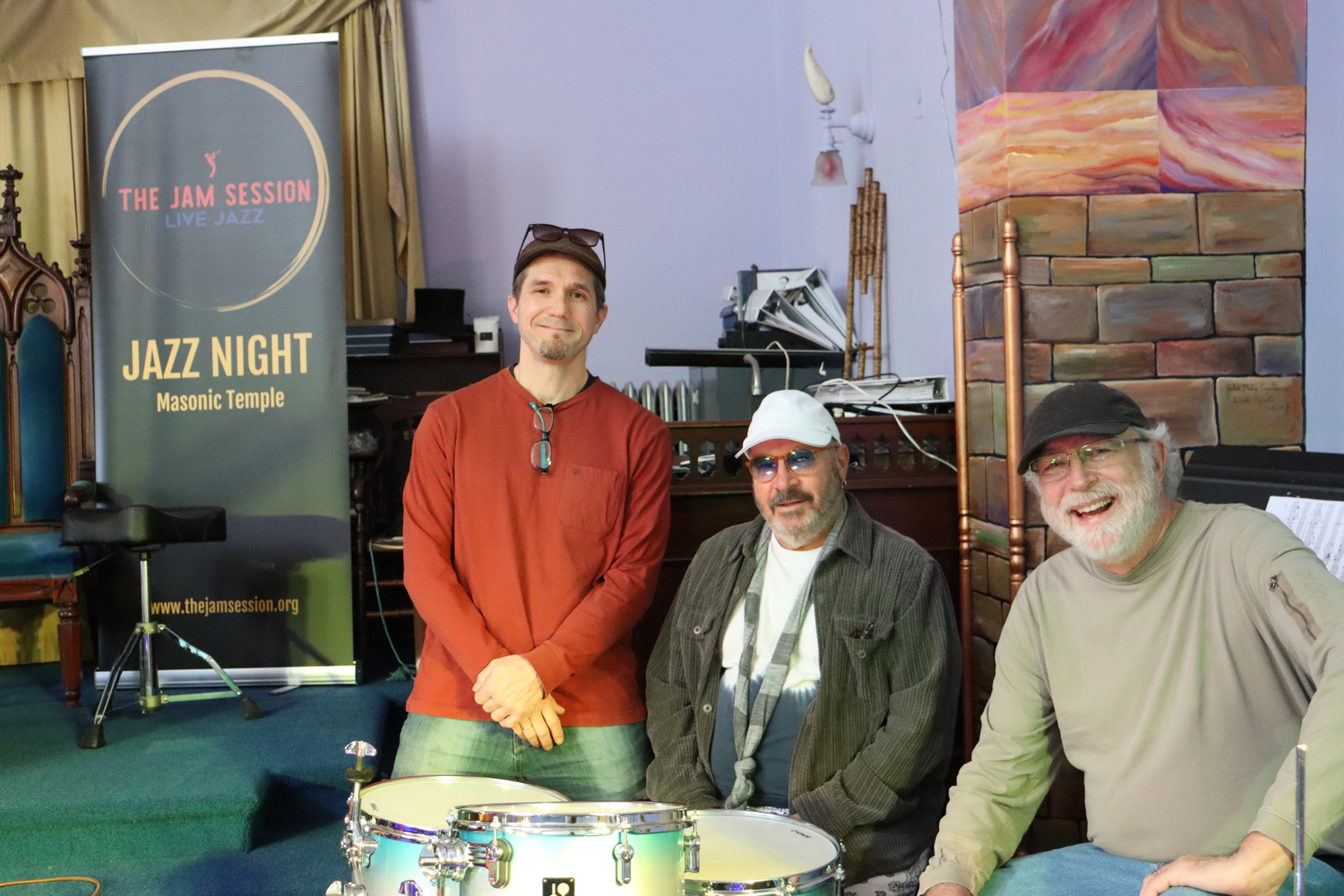 From left, Claes Brondal, Joel Chriss, and creative director Bill O'Connell at the Masonic Temple, on the second floor of the Whaling Museum, where weekly jazz nights events are held throughout the year. CAILIN RILEY