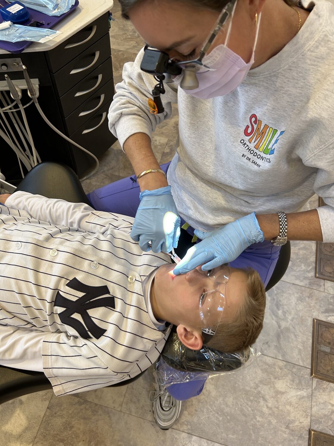 Dr. Sarah Schroetter examines her son, Hank, at Smile Orthodontics in East Hampton. PAUL SCHROETTER