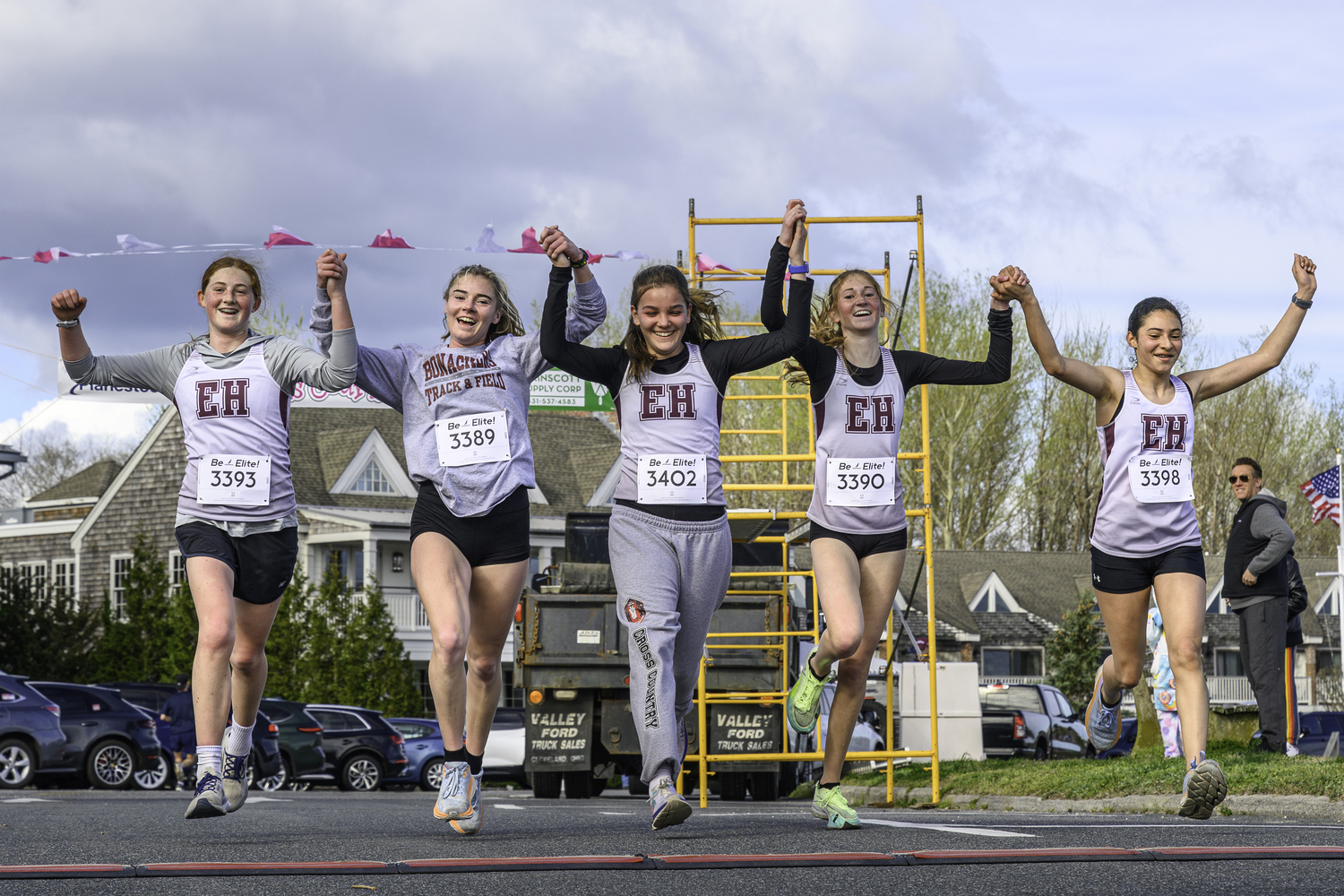 Members of the East Hampton and Pierson girls cross country and track teams cross the finish line together. From left, Josie Mott, Ryleigh O'Donnell, Greylynn Guyer, Sara O'Brien and Laura Martinez.   MARIANNE BARNETT