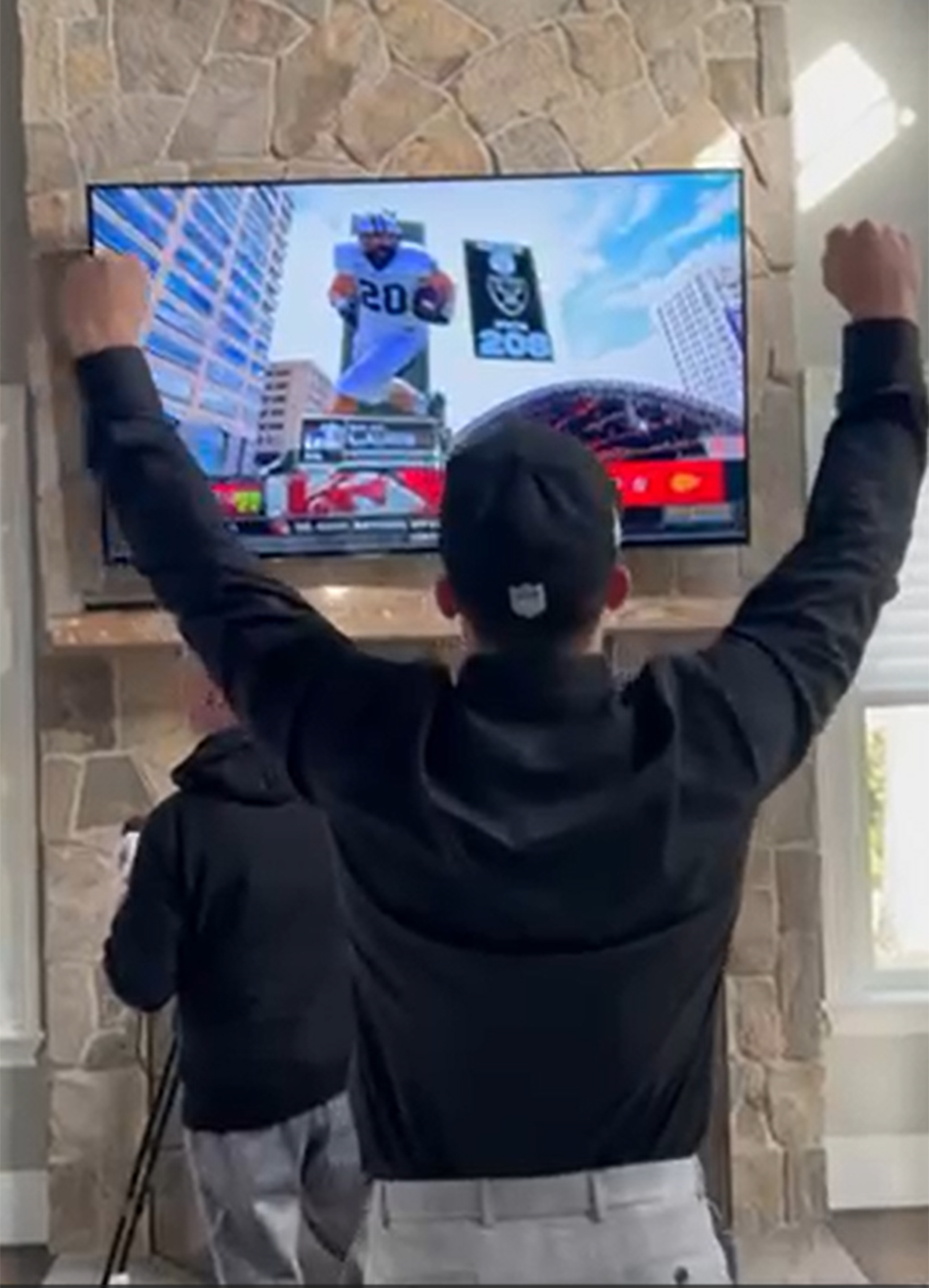 Dylan Laube raises his arms in celebration of being picked in the 2024 NFL Draft.
