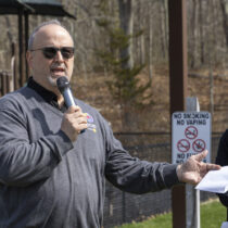 Tom Crowley of Hampton Bays, a 37-year member of the hamlet’s Rotary Club, was honored on Saturday with the dedication of a peace pole “May peace prevail on Earth,” in eight languages, at Good Ground Park.  MICHAEL O'CONNOR