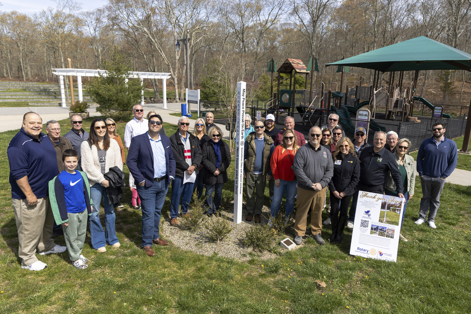 Friends and family at the Peace Pole dedication for Tom Crowley, a 37-year at Good Ground Park.  MICHAEL O'CONNOR