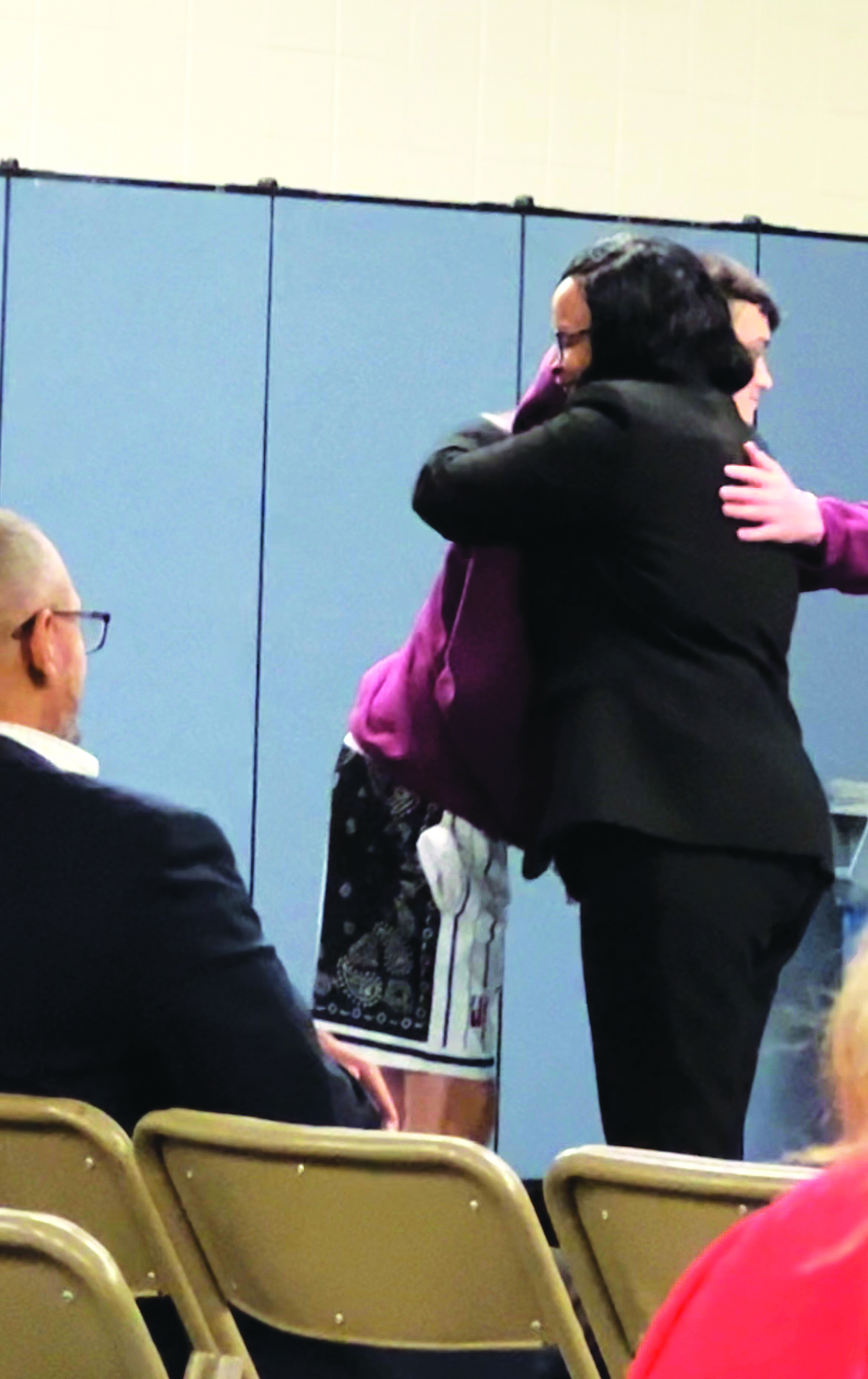 Southampton High School sophomore Noah Kent embraces newly appointed Superintendent of Schools Dr. Fatima Morrell after a heated Board of Education meeting on Tuesday night. SARA MANNINO KENT