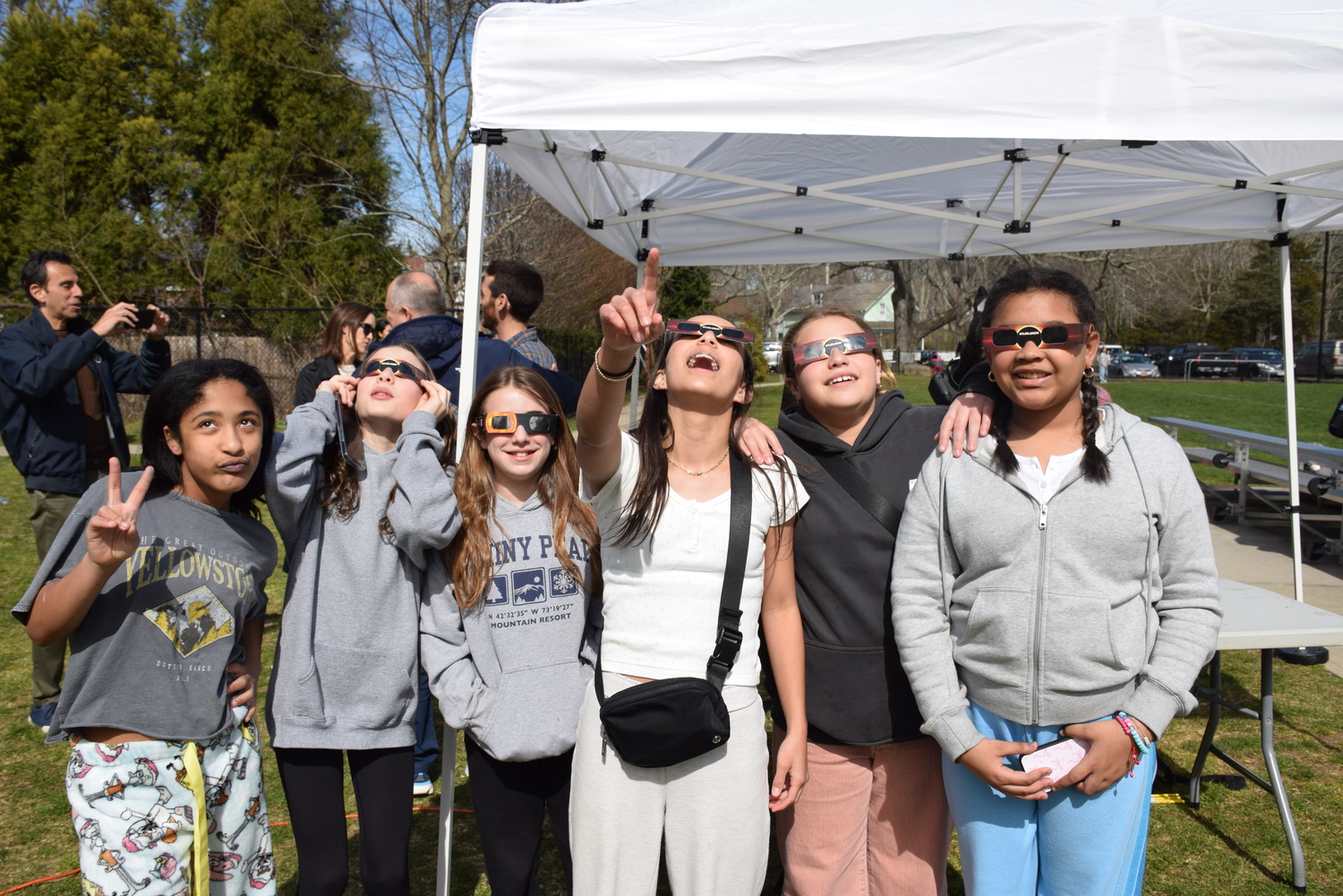 The April 8 solar eclipse, which stretched across North America, provided Pierson High and Middle school students the opportunity to see the spectacular event as a community. Immediately after school, students, faculty and parents gathered on the Pierson back field with eclipse viewing glasses in hand. From about 2:50-4:30 p.m., students played outdoor games such as basketball, soccer and frisbee, stopping on occasion to look up and view the eclipse with their glasses. Also available was a live viewing station complete with a telescope that fed to a desktop computer screen, which showed the eclipse clearly without having to look up through the tinted glasses. Food was available for everyone to enjoy and Two Shoes, a band run by two Pierson teachers, played music that featured the occasional student guest appearance. COURTESY SAG HARBOR SCHOOL DISTRICT