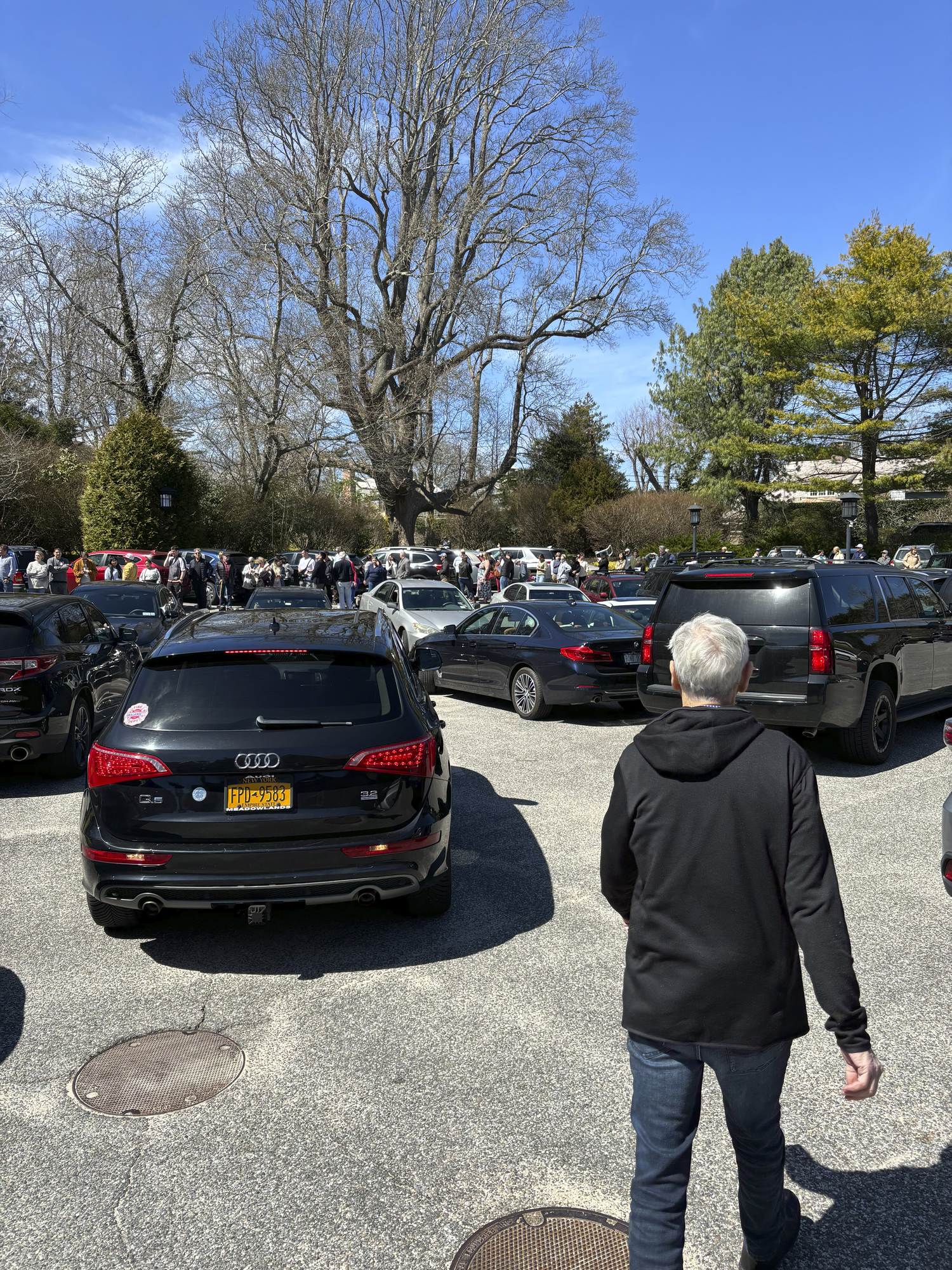 Visitors wait in line at the East Hampton Library for solar glasses on Monday afternoon.