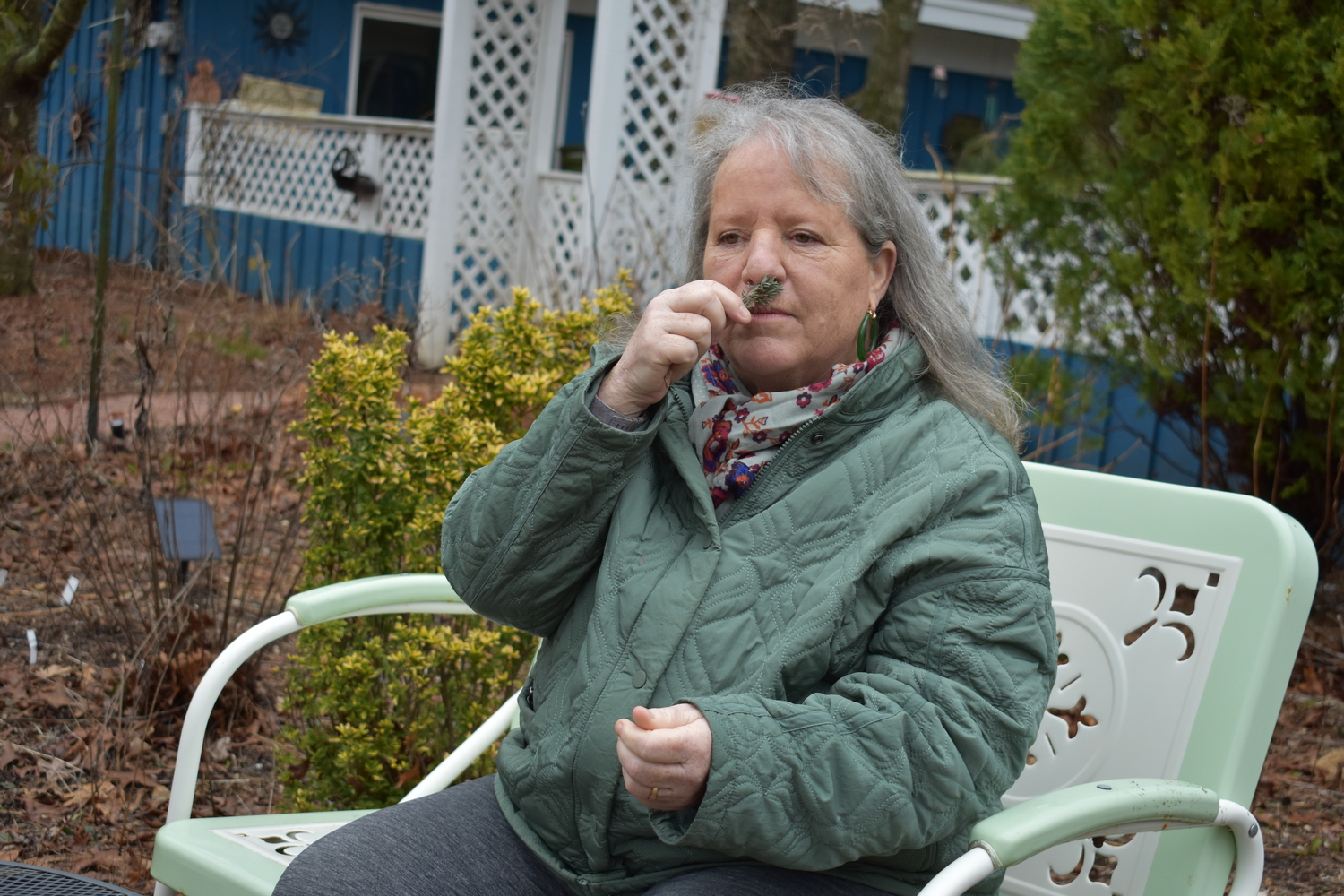 Mary Vienneau sits in her garden with aromatic herbs.  BRENDAN J. O'REILLY