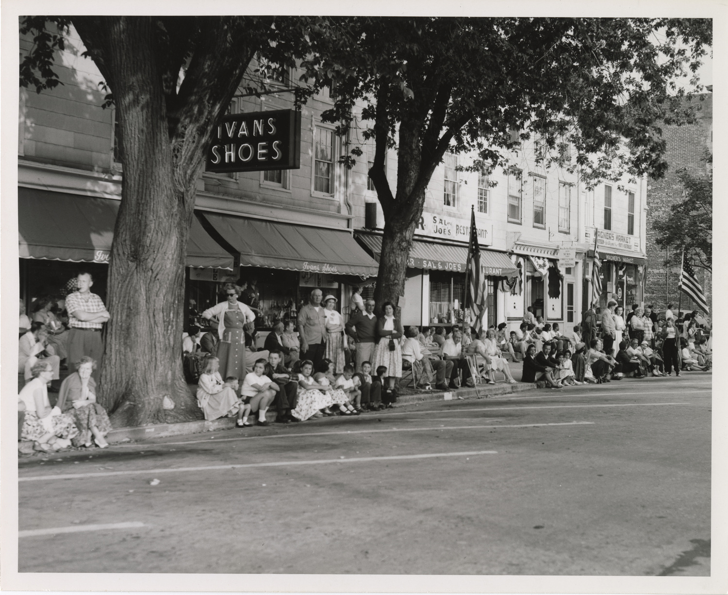Mel Jackson's photo of parade goers on Sag Harbor's Main Street in the late 1950s. COURTESY JOHN JERMAIN MEMORIAL LIBRARY