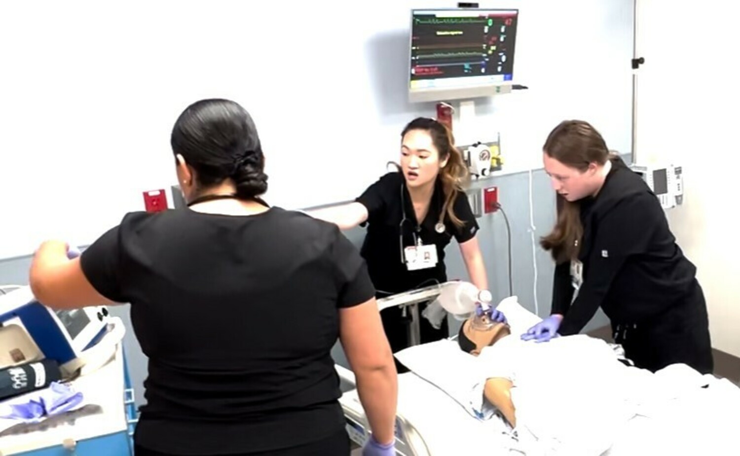 Kelly Dung Bui Bruckner, center, and Andreya Weaver administer CPR to 