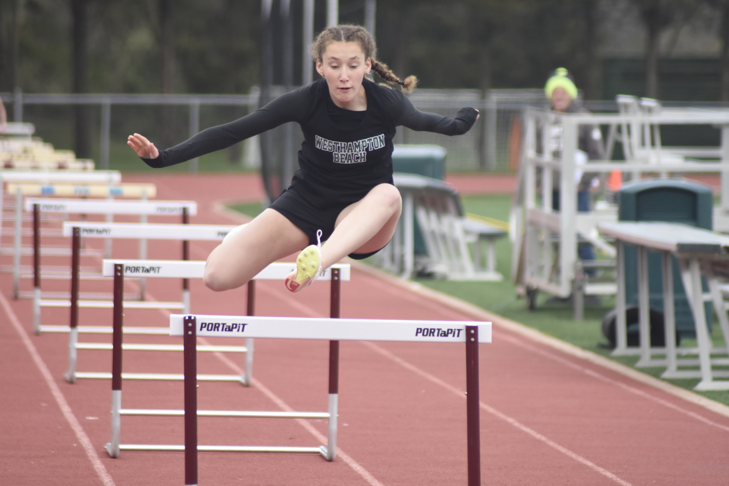 Elizabeth Sultan in the 100-meter high hurdles at a dual meet at East Hampton on April 19.  DREW BUDD