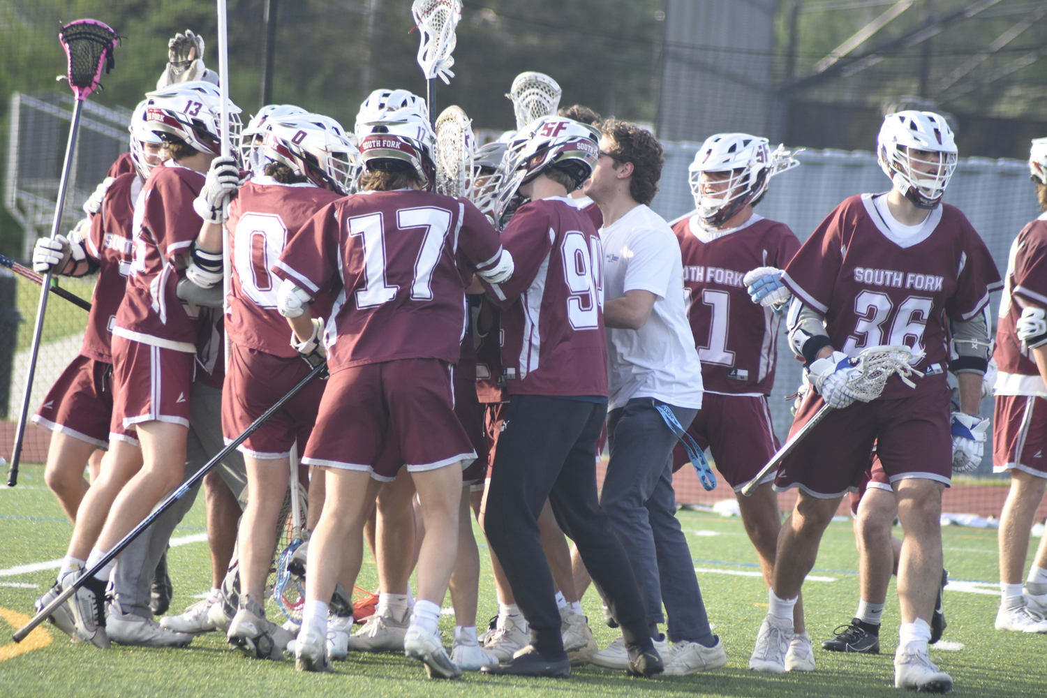 The Islanders mob goalie Oliver Edson after they defeated Commack, 14-13, on Wednesday. The victory should clinch a playoff spot for South Fork.   DREW BUDD