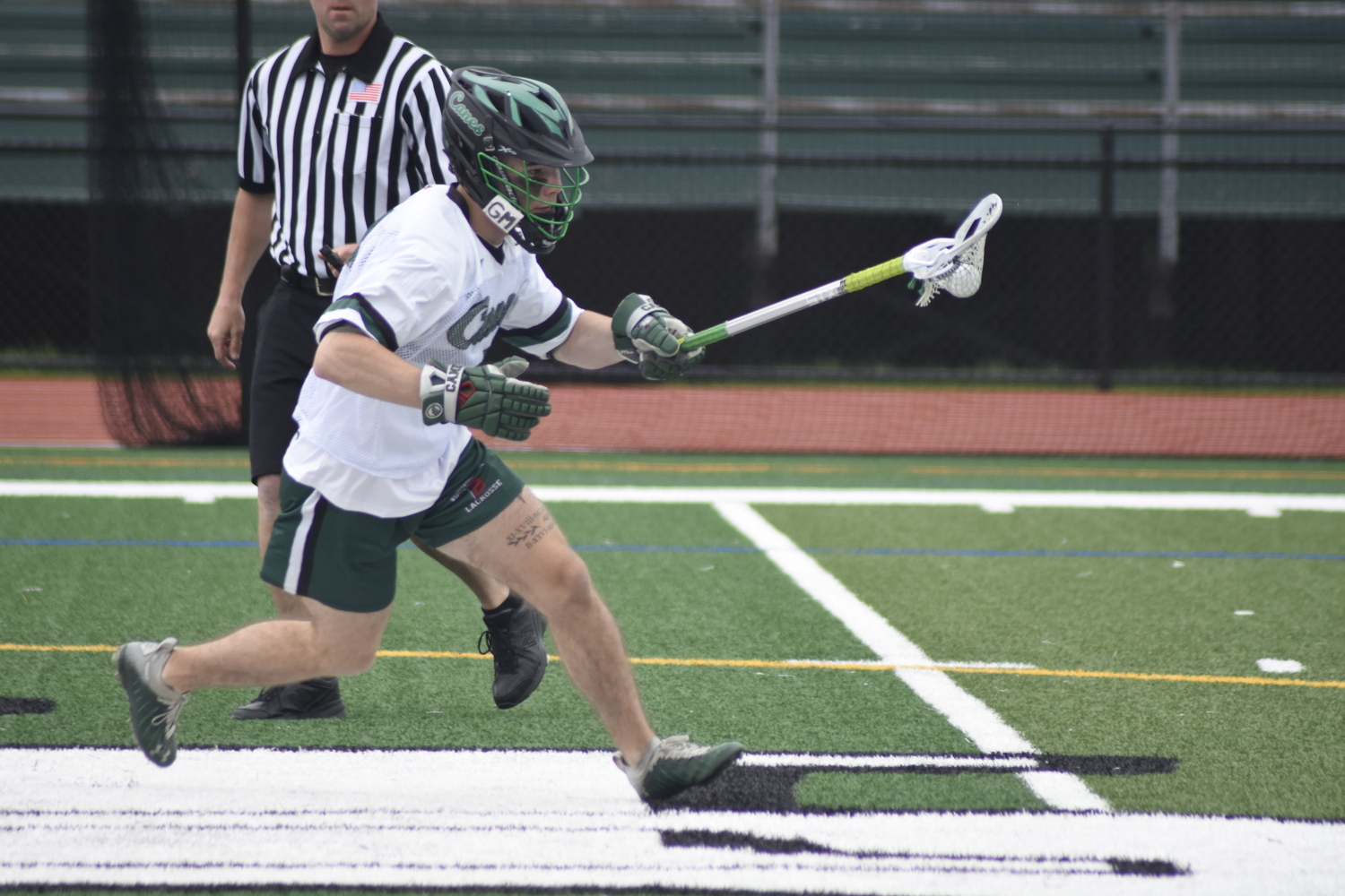 Westhampton Beach senior Nolan Michalowski picks a ball up off the opening faceoff.   DREW BUDD