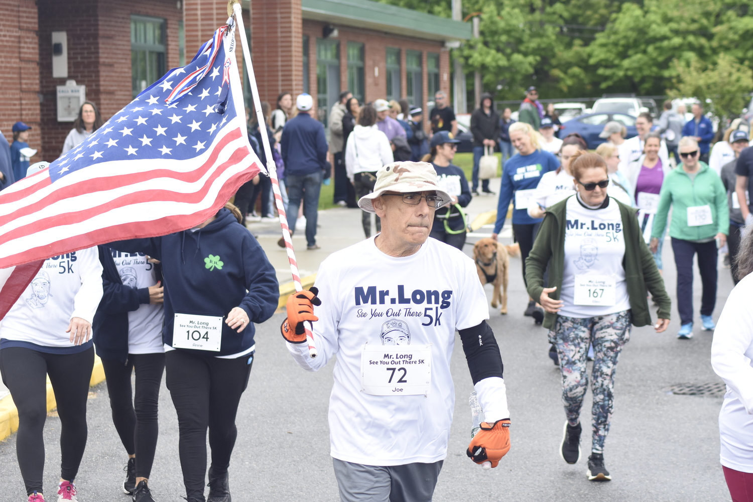 Joe Sferrazza of Manorville carries Old Glory at the start and through the race's entirety.   DREW BUDD